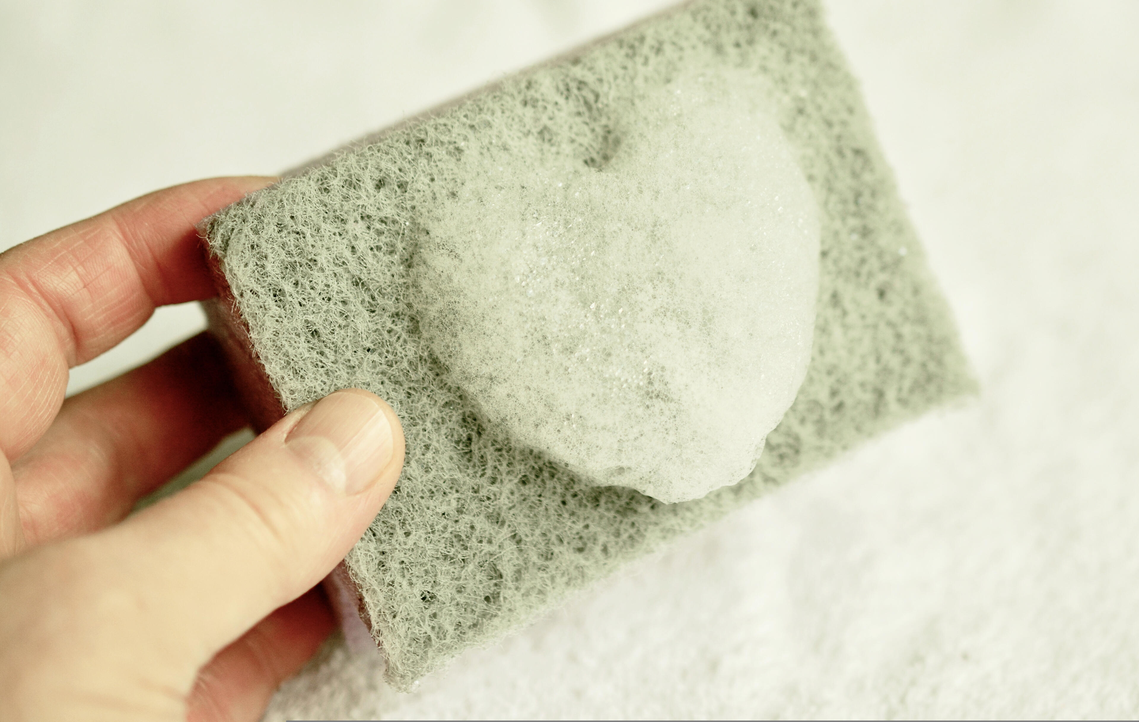 Customer Satisfaction Professional cleaner using a sponge to ensure a spotless cleaning result.